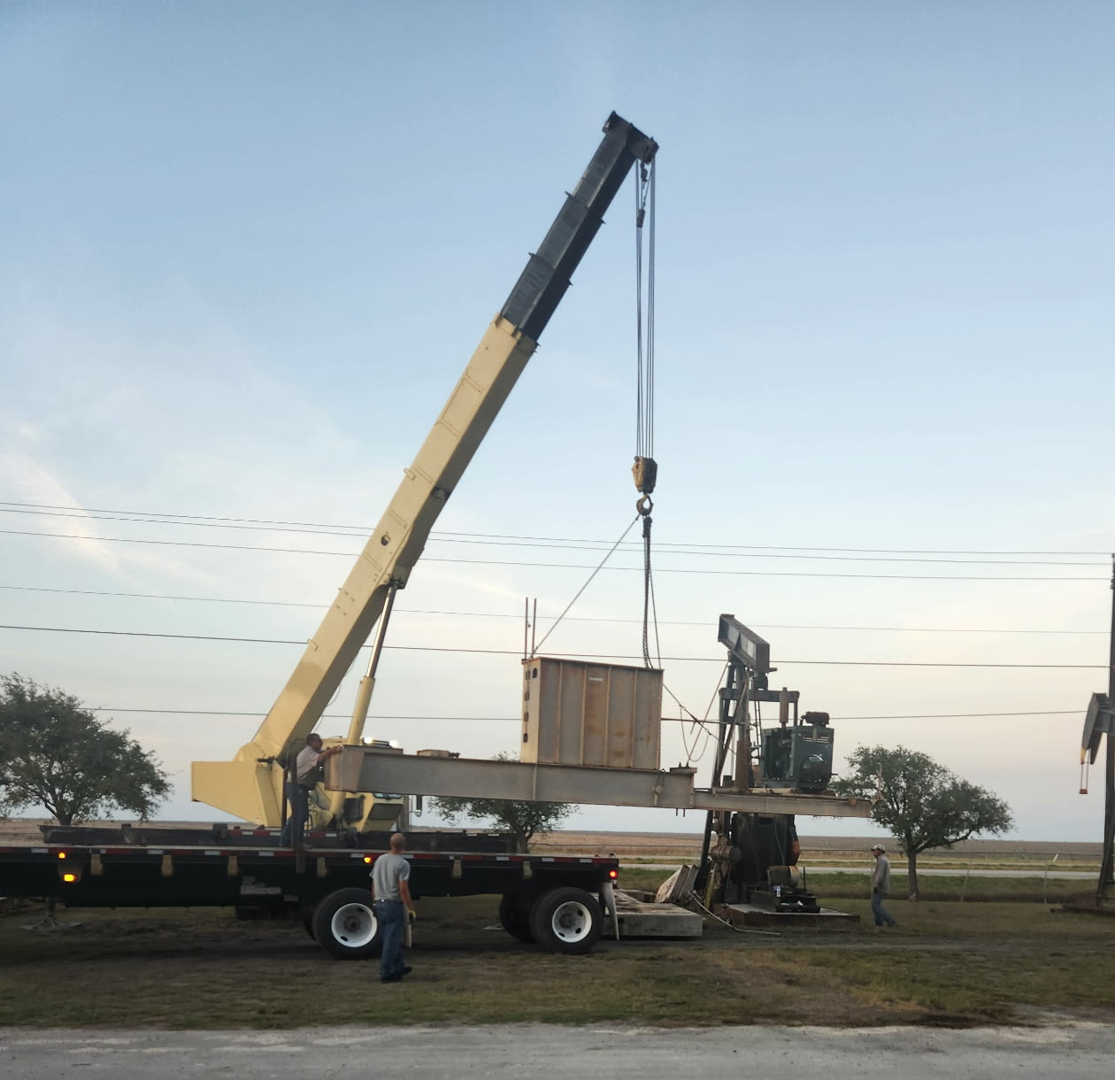 Ram-Gear field crane setting a pumping unit